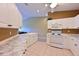 Open kitchen area with white cabinets, modern appliances, a ceiling fan, and tiled flooring for easy cleanup at 6335 Bay Cedar Ln, Bradenton, FL 34203