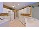 Bright kitchen with white cabinetry, modern appliances, a ceiling fan, and views into other rooms of the condo at 6335 Bay Cedar Ln, Bradenton, FL 34203