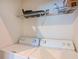 Laundry room with washer and dryer, and shelving above them at 6335 Bay Cedar Ln, Bradenton, FL 34203