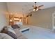 Bright, open living room with a ceiling fan, stylish lighting, and a view into the kitchen area with breakfast bar at 6335 Bay Cedar Ln, Bradenton, FL 34203