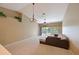 Bright living room with a ceiling fan, contemporary lighting fixtures, a loft area, and sliding door access to a balcony at 6335 Bay Cedar Ln, Bradenton, FL 34203