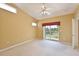 Comfortable main bedroom featuring plush carpeting, a ceiling fan, and sliding door access to a private balcony at 6335 Bay Cedar Ln, Bradenton, FL 34203