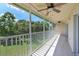Screened patio with ceiling fans overlooking trees and lawn at 6335 Bay Cedar Ln, Bradenton, FL 34203