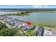 Aerial view of home showing the property's proximity to a lake, nearby residences, and lush greenery at 6349 Isla Del Ray Ave, Sarasota, FL 34240