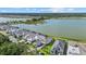 Aerial view of home showing the property's proximity to a lake, nearby residences, and lush greenery at 6349 Isla Del Ray Ave, Sarasota, FL 34240