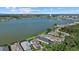 Scenic aerial view showcasing the lakefront homes nestled amidst lush green forests and a serene lake at 6349 Isla Del Ray Ave, Sarasota, FL 34240