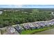 Stunning aerial view of a neighborhood featuring modern homes, serene lake views, and lush green surroundings at 6349 Isla Del Ray Ave, Sarasota, FL 34240