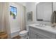 Bright bathroom featuring a shower over tub, a stylish mirror, a sink, and decorative accessories at 6349 Isla Del Ray Ave, Sarasota, FL 34240