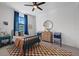 Bright bedroom featuring a blue bed frame, brown and white checkered rug, and a ceiling fan at 6349 Isla Del Ray Ave, Sarasota, FL 34240