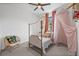 Cozy bedroom boasts a gold-frame bed, a side table, and a chair, complete with an accent canopy at 6349 Isla Del Ray Ave, Sarasota, FL 34240