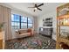 Charming bedroom features a beautiful water view, a ceiling fan, and a comfortable seating area with unique decor at 6349 Isla Del Ray Ave, Sarasota, FL 34240