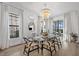 Bright dining room featuring glass table, chandelier, and decorative mirrors at 6349 Isla Del Ray Ave, Sarasota, FL 34240