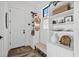 Bright entryway featuring white door, decor shelving, and bench at 6349 Isla Del Ray Ave, Sarasota, FL 34240
