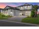 Beautiful home with manicured lawn, brick driveway, 3-car garage and decorative exterior lighting at 6349 Isla Del Ray Ave, Sarasota, FL 34240
