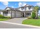 Charming two-story home with a three-car garage, well-manicured lawn, and a paver driveway at 6349 Isla Del Ray Ave, Sarasota, FL 34240