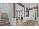 Elegant foyer featuring hardwood floors, a chandelier, and a staircase leading to the upper level at 6349 Isla Del Ray Ave, Sarasota, FL 34240