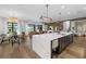 Open kitchen featuring expansive marble-top island, modern pendant lighting, and views into the dining and Gathering rooms at 6349 Isla Del Ray Ave, Sarasota, FL 34240