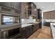 An angled view of an oven, gas range, and cabinetry in a kitchen with marble backsplash at 6349 Isla Del Ray Ave, Sarasota, FL 34240