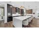 The kitchen features a large island, bar seating, custom cabinets, and stainless steel appliances at 6349 Isla Del Ray Ave, Sarasota, FL 34240