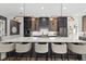 The kitchen features a large island, bar seating, designer lighting, and stainless steel appliances at 6349 Isla Del Ray Ave, Sarasota, FL 34240