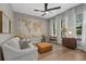 Bright and airy living room with a world map wall decor, wooden floors, and modern furnishings at 6349 Isla Del Ray Ave, Sarasota, FL 34240