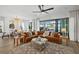 Open living room boasts hardwood floors, stylish decor, and expansive sliding doors to the lanai at 6349 Isla Del Ray Ave, Sarasota, FL 34240
