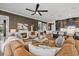 Cozy living room with a fireplace, stylish decor, and open to the kitchen and dining area at 6349 Isla Del Ray Ave, Sarasota, FL 34240