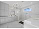 Luxurious main bathroom featuring a chandelier, marble floors, and a spacious walk-in shower at 6349 Isla Del Ray Ave, Sarasota, FL 34240