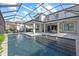 A beautifully screened in pool featuring a modern design with fountains and seating area at 6349 Isla Del Ray Ave, Sarasota, FL 34240