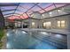 Inviting outdoor pool area with covered patio, stylish furniture, and screened enclosure at 6349 Isla Del Ray Ave, Sarasota, FL 34240
