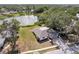 Panoramic aerial view of a home near a serene lake, surrounded by lush greenery and mature trees at 6572 Mauna Loa Blvd, Sarasota, FL 34241