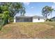Backyard with a screened-in patio and lush landscaping at 6572 Mauna Loa Blvd, Sarasota, FL 34241