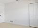 Clean bedroom with light-colored wood-look floors and white paint. Features a closet and bright light at 6572 Mauna Loa Blvd, Sarasota, FL 34241