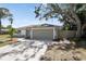 Charming single-story home featuring a spacious two-car garage, complemented by well-maintained landscaping at 6572 Mauna Loa Blvd, Sarasota, FL 34241