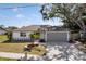 Charming single-story home with a well-maintained lawn, decorative landscaping, and a two-car garage at 6572 Mauna Loa Blvd, Sarasota, FL 34241