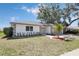 Well-manicured front lawn with decorative landscaping and a charming single-story home at 6572 Mauna Loa Blvd, Sarasota, FL 34241