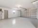 Spacious garage with speckled floors and an automatic door, ready for parking and storage at 6572 Mauna Loa Blvd, Sarasota, FL 34241