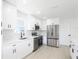 Well-lit kitchen with white cabinets, stainless steel appliances, and ample counter space, creating a modern and functional area at 6572 Mauna Loa Blvd, Sarasota, FL 34241