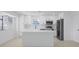 Modern kitchen with white cabinetry, stainless steel appliances, and a center island, offering ample counter space at 6572 Mauna Loa Blvd, Sarasota, FL 34241