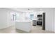 Modern kitchen featuring white cabinetry, stainless steel appliances, and a functional center island at 6572 Mauna Loa Blvd, Sarasota, FL 34241
