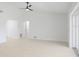 Bright living room with ceiling fan, white walls and light wood-look floors, providing an airy and open space at 6572 Mauna Loa Blvd, Sarasota, FL 34241