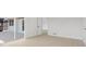 Open-concept living area featuring light-colored flooring, and access to a screened in porch, maximizing indoor-outdoor living at 6572 Mauna Loa Blvd, Sarasota, FL 34241