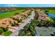 Wide aerial perspective of the real estate showing the road, golf course, pond, and tennis court at 7106 Grand Estuary Trl # 102, Bradenton, FL 34212