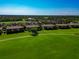 Stunning aerial view showcasing the community's expansive golf course, serene ponds, and well-manicured landscaping at 7106 Grand Estuary Trl # 102, Bradenton, FL 34212