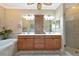 Bright bathroom featuring a double vanity, soaking tub, and walk-in shower at 7106 Grand Estuary Trl # 102, Bradenton, FL 34212