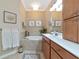 Bright bathroom featuring a soaking tub with tile surround, framed art and spacious vanity at 7106 Grand Estuary Trl # 102, Bradenton, FL 34212