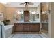 Elegant bathroom featuring double vanity, soaking tub, and glass-enclosed shower at 7106 Grand Estuary Trl # 102, Bradenton, FL 34212