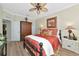 Charming bedroom showcasing a black bed, floral bedding, and coordinating decor at 7106 Grand Estuary Trl # 102, Bradenton, FL 34212