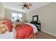 Bedroom featuring a ceiling fan, bright window and black console table at 7106 Grand Estuary Trl # 102, Bradenton, FL 34212