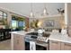 Modern kitchen with an island cooktop, views of the living area, and outdoor space at 7106 Grand Estuary Trl # 102, Bradenton, FL 34212